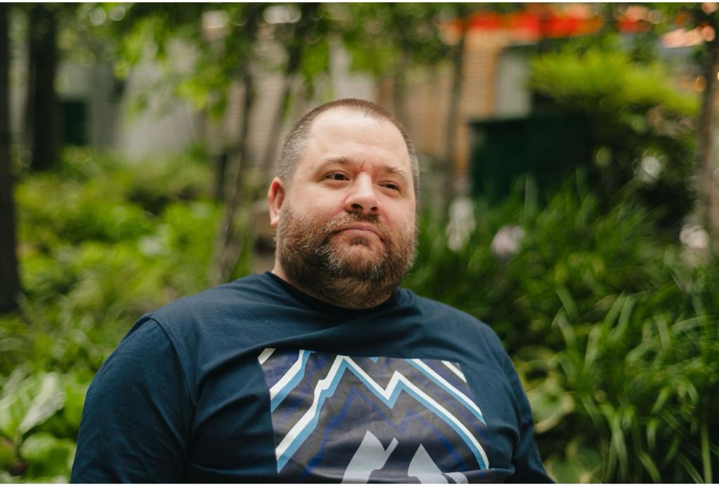 Disabled Speaker Scott Whitney, staring in to this distance wearing a navy blue t shirt